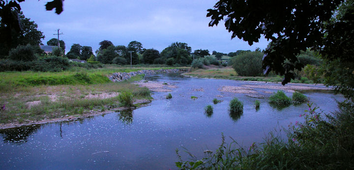 The River Otter at Tipton St John at the end of a warm, cloudy and humid July day.