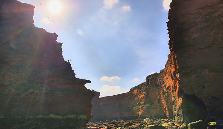 Spectacular Triassic sandstone cliffs and sea stacks at the western end of Jacob's Ladder Beach, Sidmouth on a warm and sunny March day.