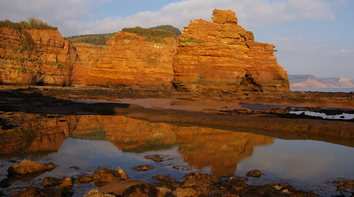 Spectacular Triassic sandstone sea stacks at the western end of Jacob's Ladder Beach, Sidmouth on a warm and sunny February day.